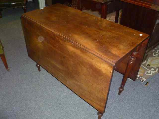 Appraisal: A VICTORIAN MAHOGANY DROP FLAP DINING TABLE on turned tapering