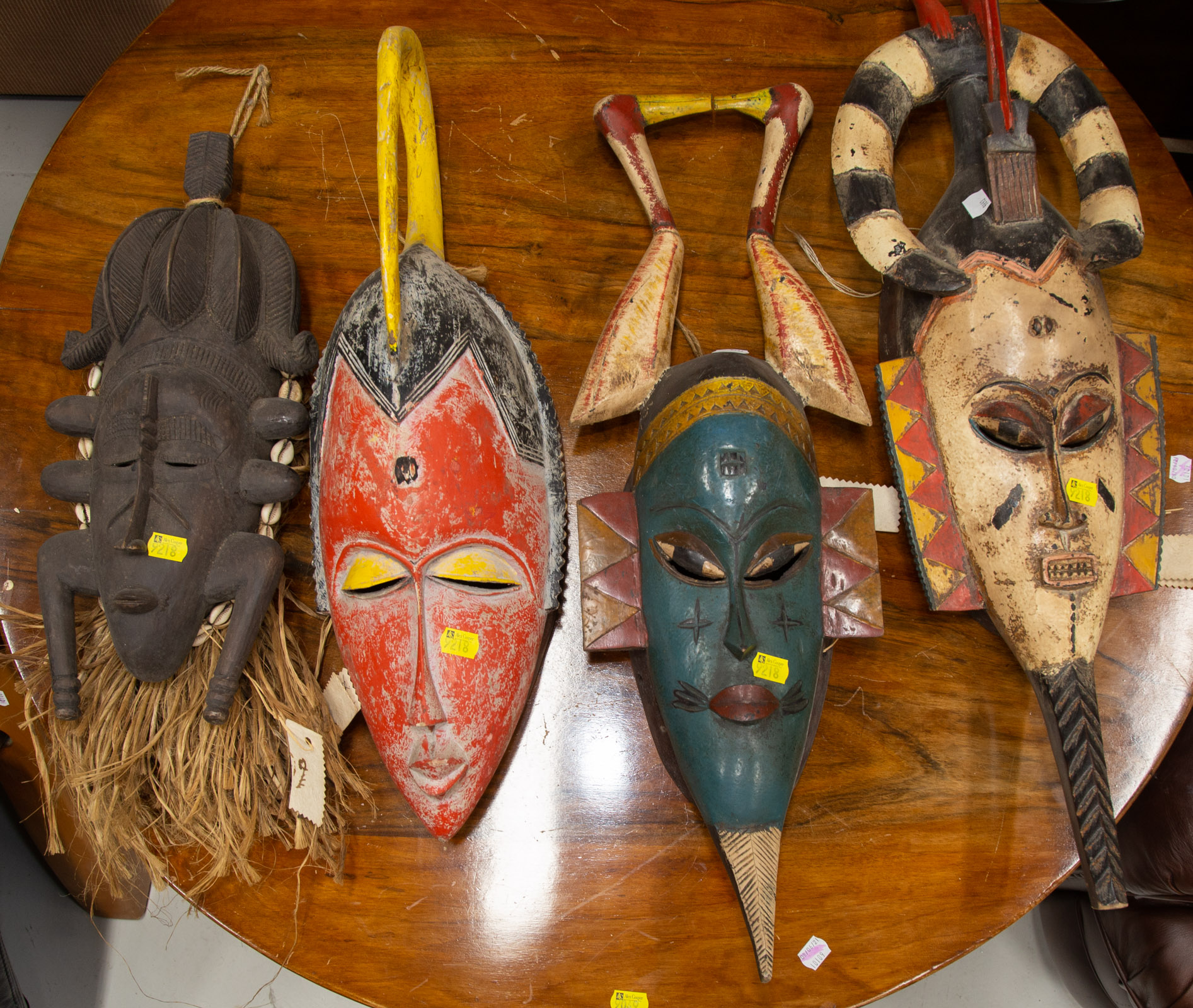 Appraisal: FOUR DECORATIVE AFRICAN MASKS th century including three Gouro painted