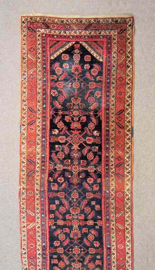 Appraisal: An antique Hamadan runner woven in colours with Herati variations