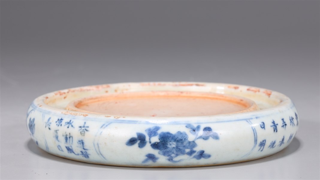 Appraisal: Chinese circular form blue and white ink stone with calligraphy