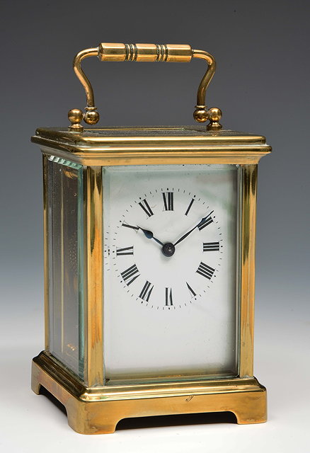 Appraisal: A French brass carriage timepiecewith white enamel Roman dial platform