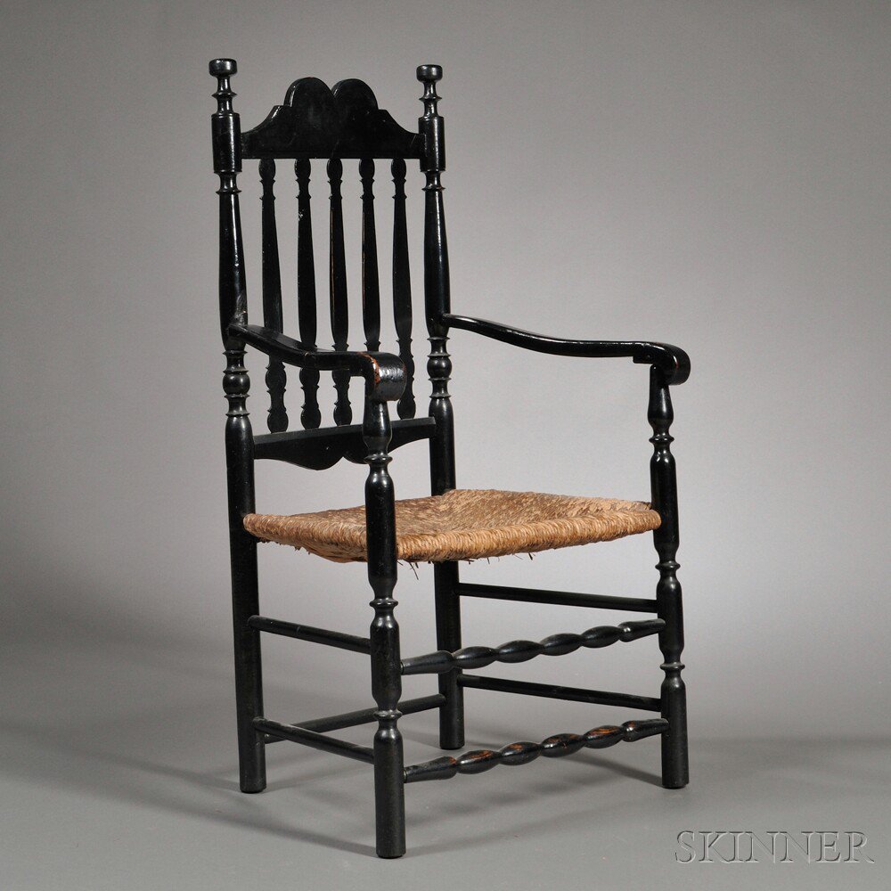 Appraisal: Black-painted Bannister-back Armchair New England th century the shaped crest