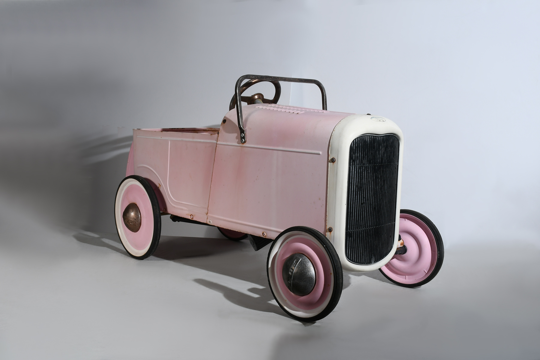 Appraisal: PINK STYLE FORD DEUCE ROADSTER PEDAL CAR Fun pink style