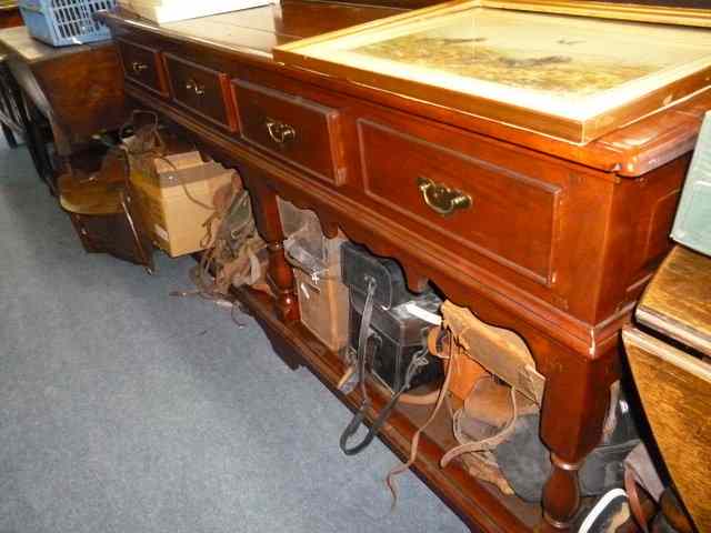 Appraisal: A HARDWOOD DRESSER with four short drawers over turned legs