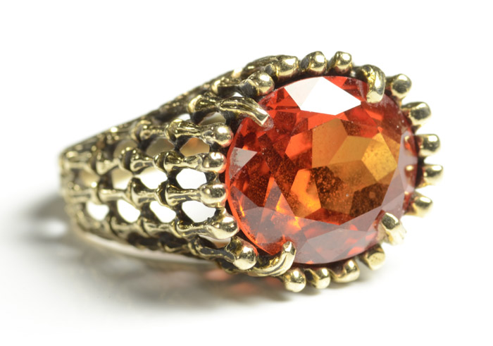 Appraisal: ORANGE SAPPHIRE AND TEN KARAT GOLD RING set with a