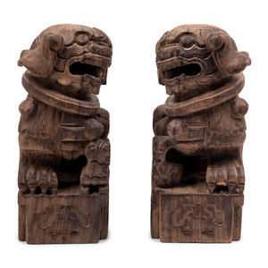 Appraisal: A Pair of Carved Wood Buddhistic Lions Height inches Property