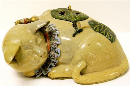 Appraisal: Late th century Kutani sleeping cat censor with leaf form