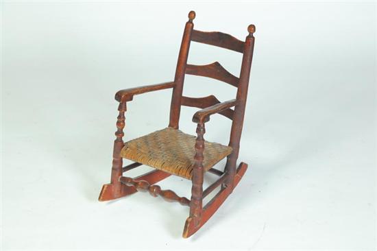 Appraisal: CHILD'S LADDERBACK ARMCHAIR ROCKER American th century mixed woods Good