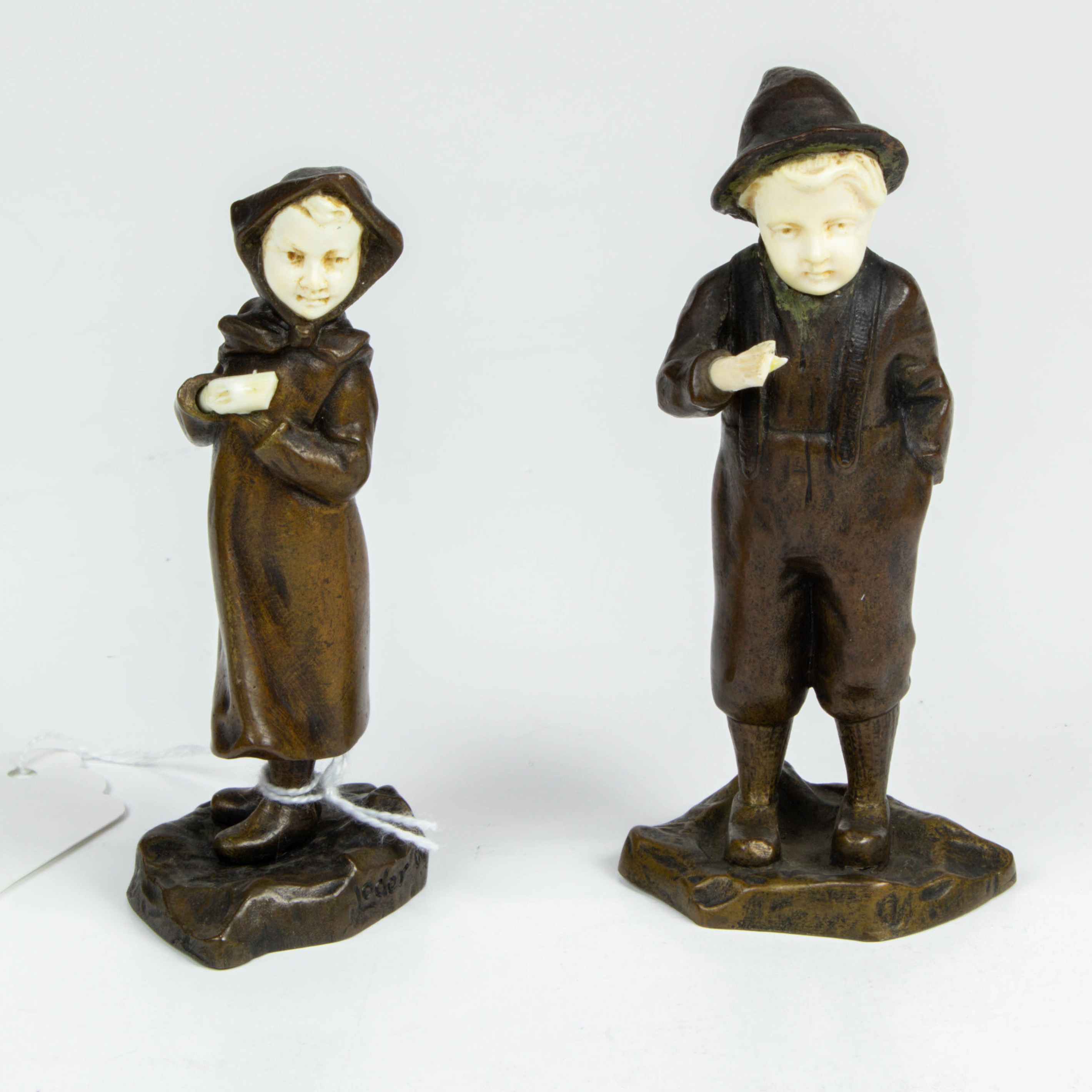 Appraisal: PAIR OF CONTINENTAL BONE INLAID PATINATED BRONZE MINIATURE FIGURES OF