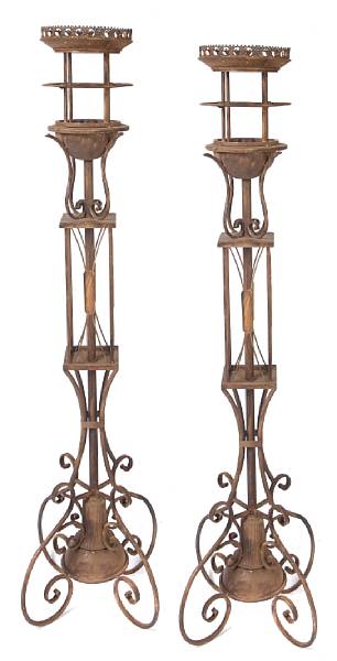 Appraisal: A pair of wrought iron floor torcheres with glass shades