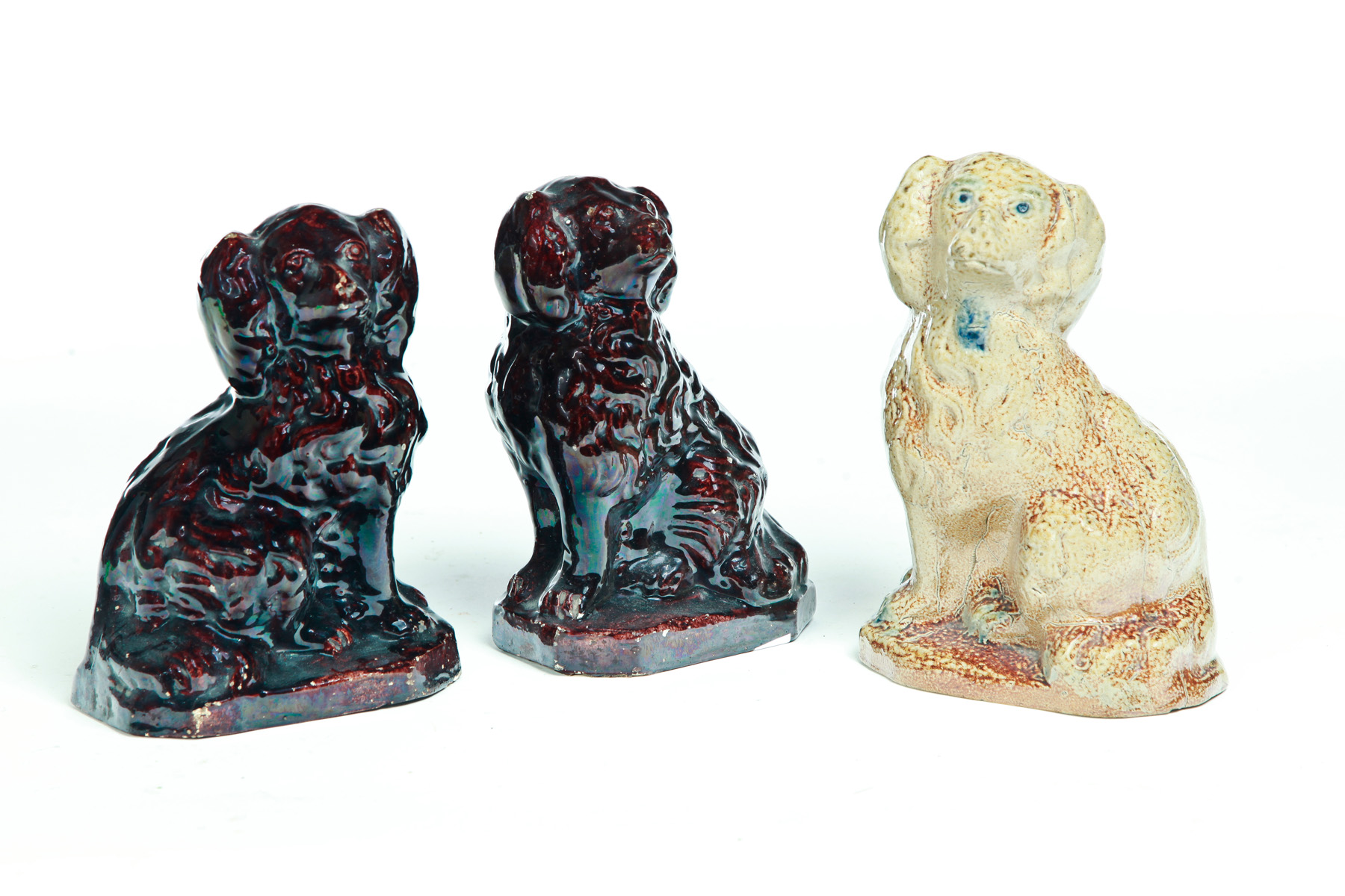 Appraisal: THREE AMERICAN POTTERY DOGS Second half- th century Pair of