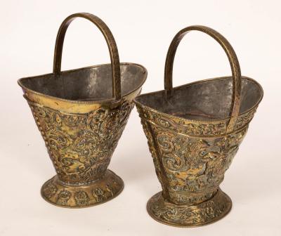 Appraisal: A pair of embossed brass coal buckets with handles