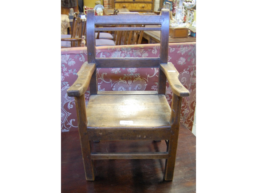 Appraisal: Late Georgian fruitwood child's elbow chair with panelled seat