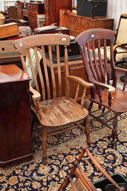 Appraisal: A LATHBACK WINDSOR ARMCHAIR with scrolling arms and turned tapering