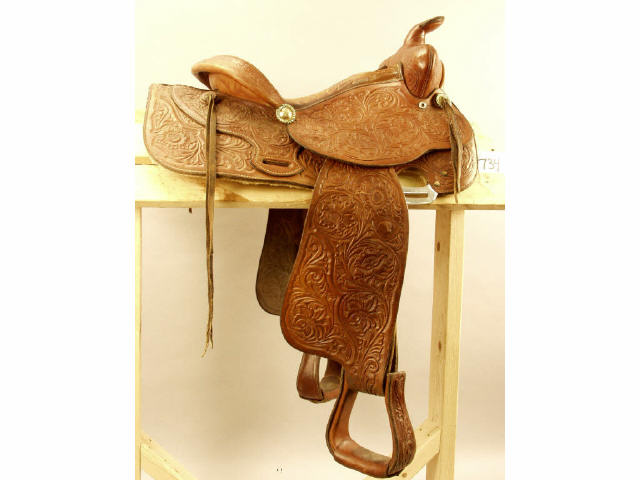 Appraisal: Unmarked floral tooled Western saddle with padded seat overall good