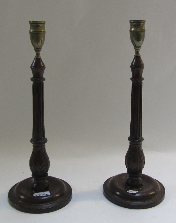 Appraisal: A pair of George III mahogany candlesticks with fluted columns