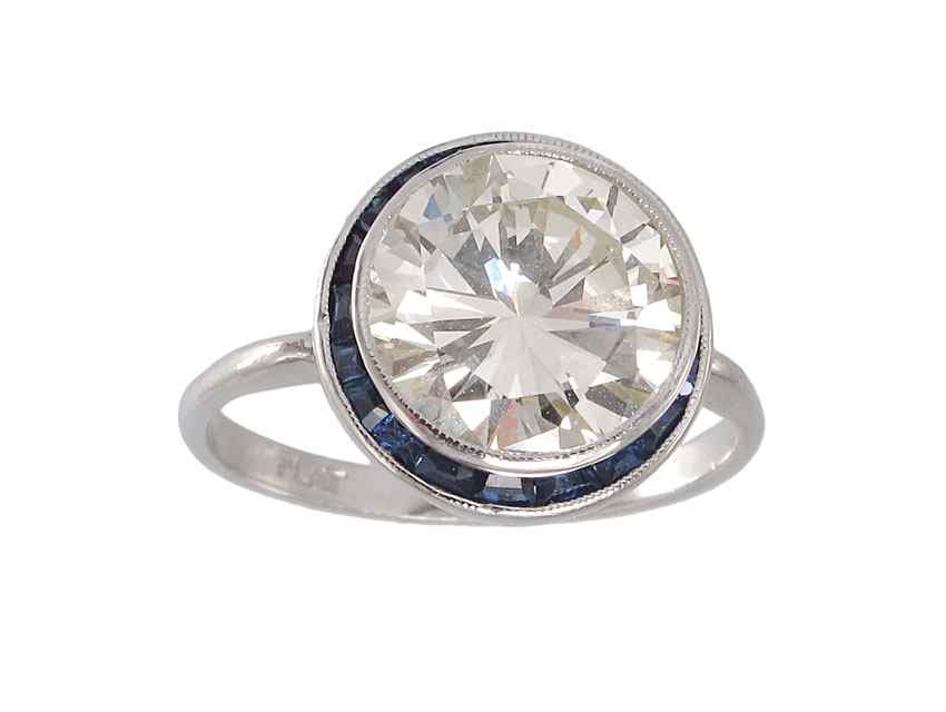 Appraisal: CT DIAMOND SOLITAIRE RING FRAMED IN SAPPHIRES Platinum ring centers