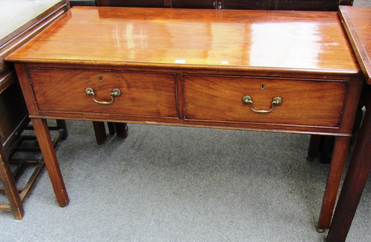 Appraisal: An th century mahogany two drawer side table on canted