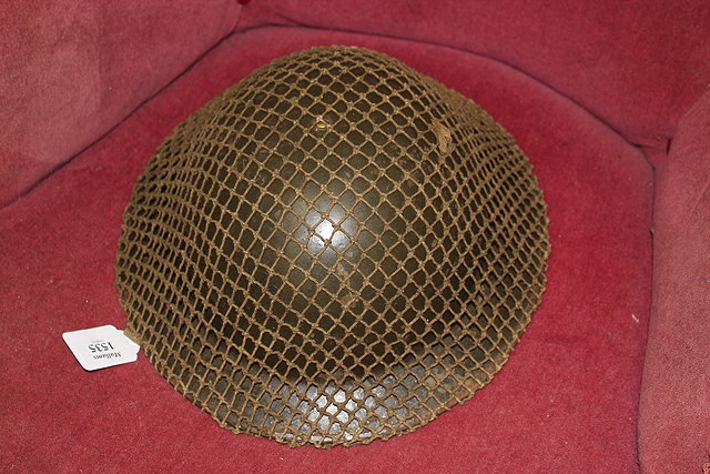 Appraisal: A WWII HELMET with original netting cm wide