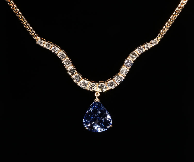 Appraisal: A K yellow gold sapphire and diamond necklace Centering a