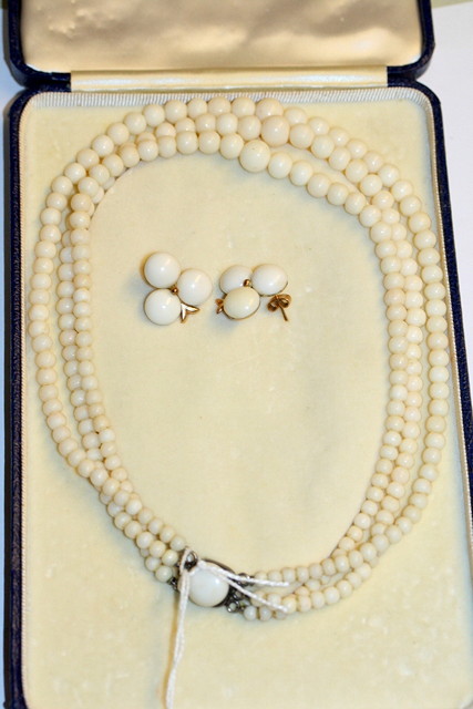 Appraisal: A WHITE CORAL THREE STRAND NECKLACE and a pair of