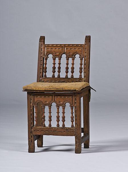 Appraisal: SPANISH CARVED WALNUT CHAIR th century with chip-carved rails turned