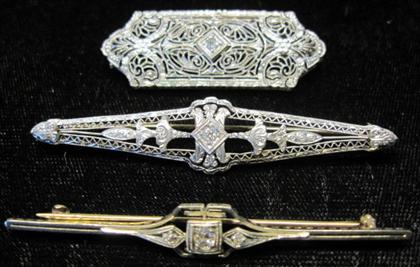 Appraisal: Three filigree and diamond pinsOne karat white gold displaying an