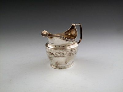 Appraisal: A George III silver cream jug maker's mark worn London