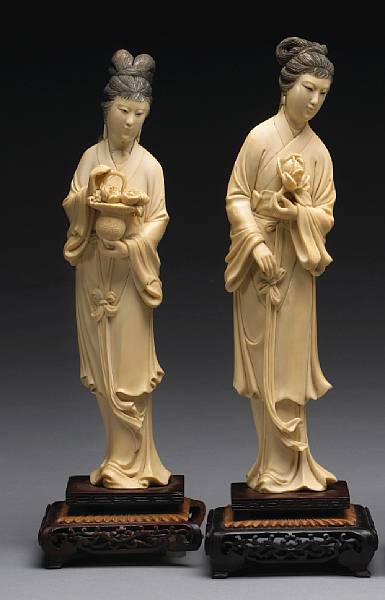 Appraisal: A pair of tinted ivory beauties th Century Each chastely