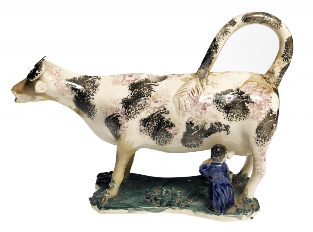 Appraisal: A CREAMWARE COW CREAMER with the diminutive figure of a