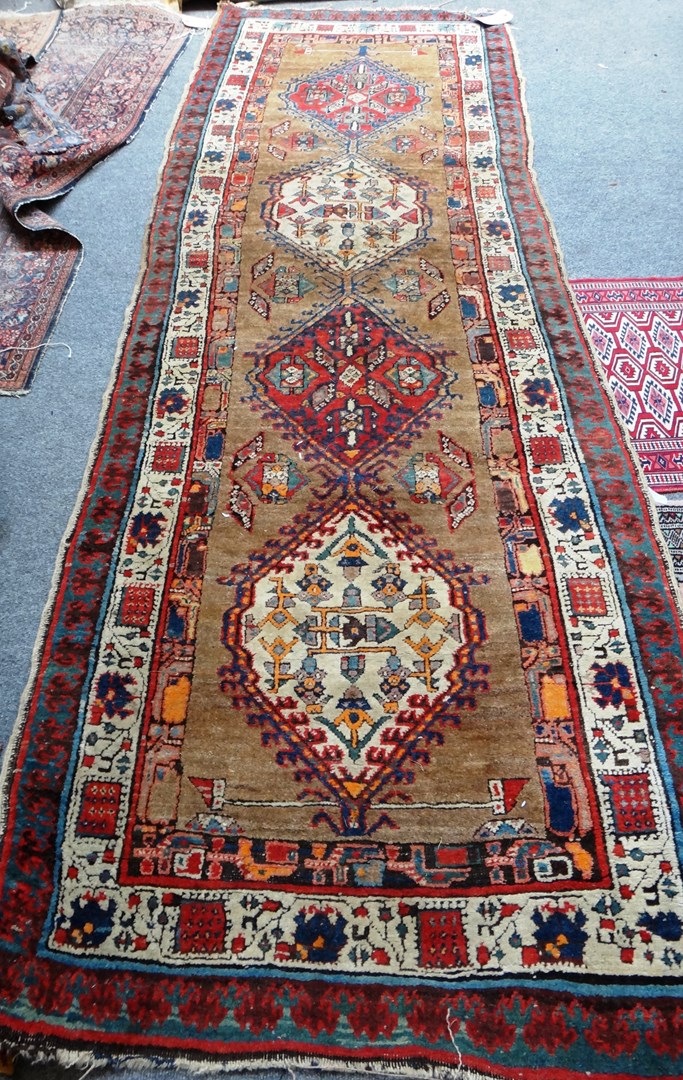 Appraisal: An Heriz runner Persian the brown field with two madder