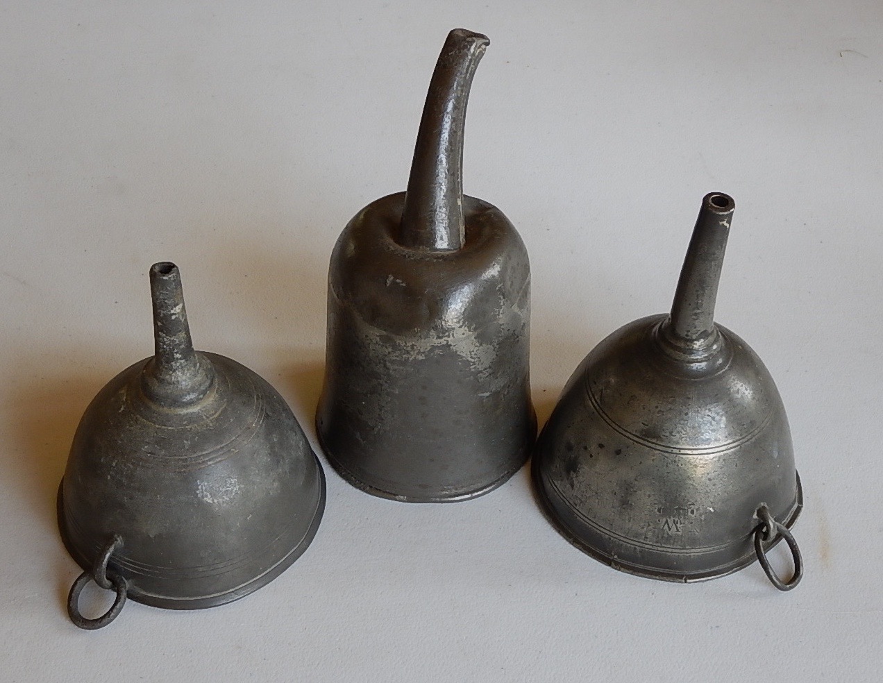 Appraisal: Three various thC pewter funnels one with interior strainer