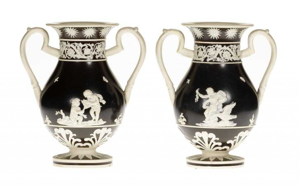 Appraisal: A PAIR OF STAFFORDSHIRE FELSPATHIC STONEWARE TWO HANDLED VASES the