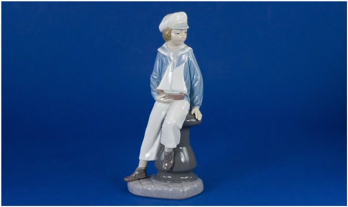 Appraisal: Lladro Figure Boy with boat No inches in height