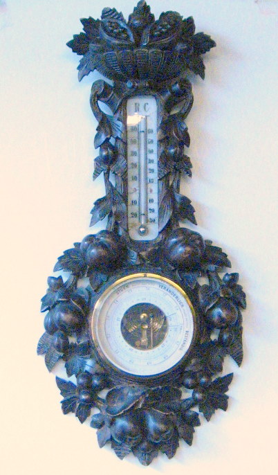 Appraisal: Black Forest carved wood thermometer barometer th century H in