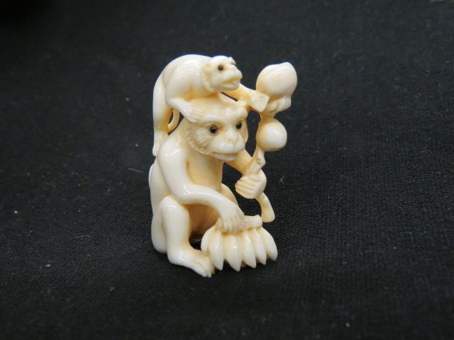 Appraisal: Carved Ivory Netsuke of Monkeyswith peaches banana's onyx eyes signed