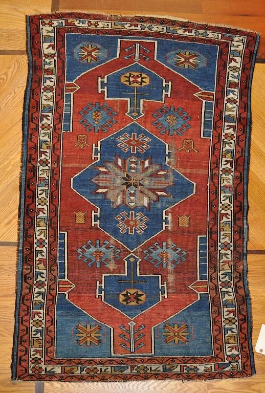 Appraisal: Caucasian Rug in blue and red tones Pile wear loss