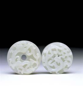 Appraisal: TWO ANTIQUE WHITE JADE BI Two antique Chinese carved white