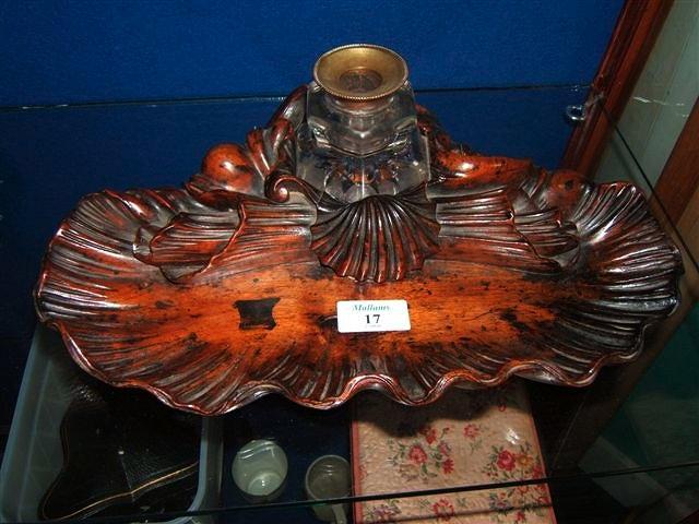 Appraisal: A Victorian walnut ink well in a shell shaped stand