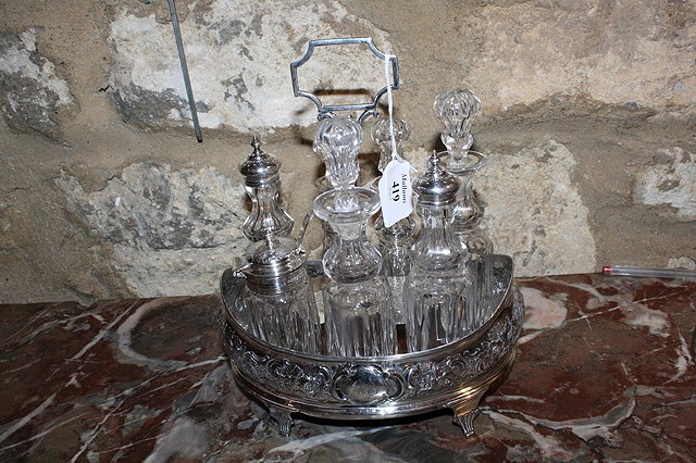 Appraisal: A GEORGIAN SILVER CRUET STAND oval shaped with chased foliate