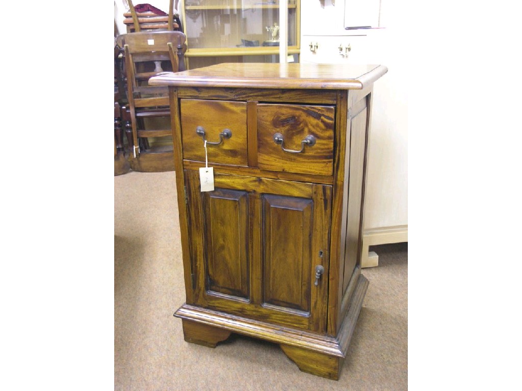 Appraisal: A mahogany cupboard two drawers above panelled door ft in