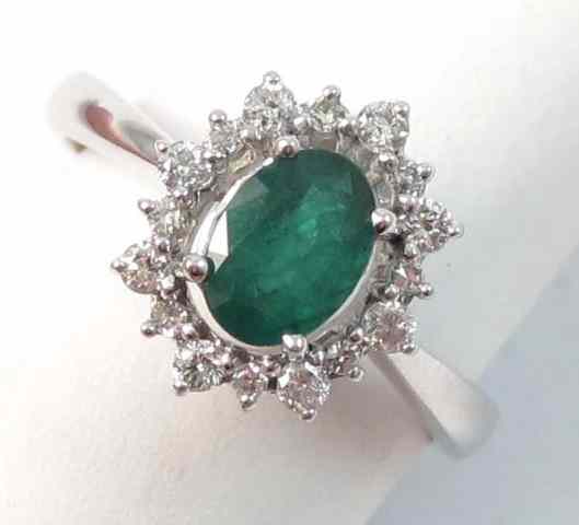 Appraisal: EMERALD DIAMOND AND FOURTEEN KARAT GOLD RING round-cut diamonds surround