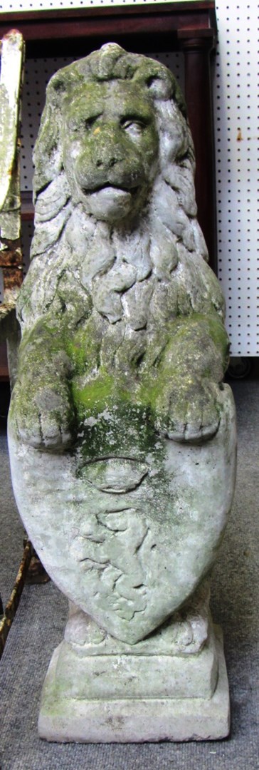 Appraisal: A pair of reconstructed stone figures of seated armorial lions