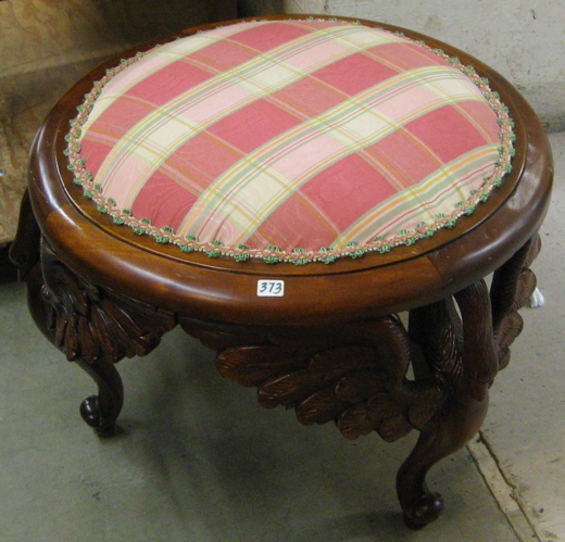 Appraisal: A ROUND CARVED MAHOGANY FOOTSTOOL having a circular padded seat