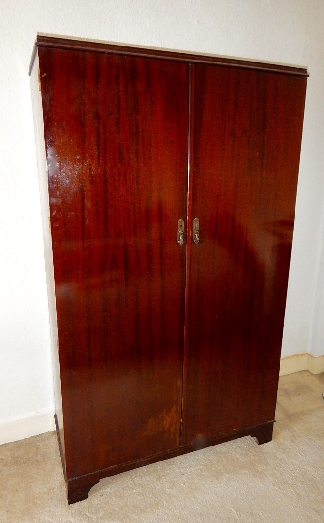 Appraisal: A mahogany valet compactum wardrobe enclosed by two doors and