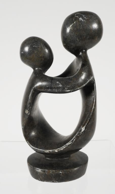 Appraisal: Abstract polished carving of two figures with arms joined Rock