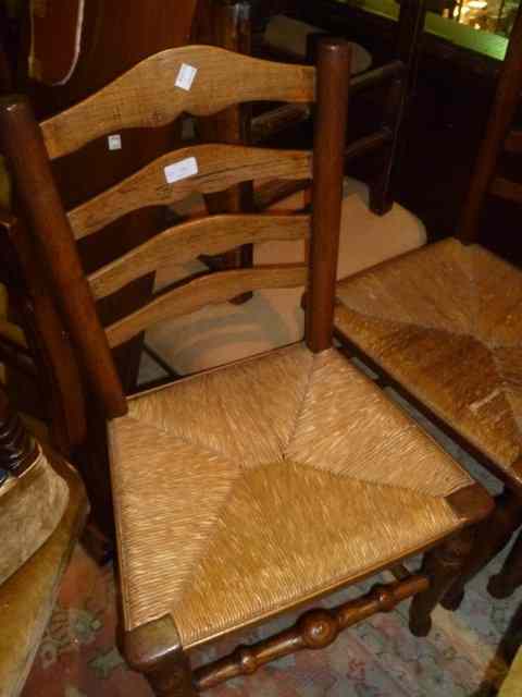 Appraisal: A HARLEQUIN SET OF FOUR GEORGIAN ELM LADDERBACK CHAIRS with