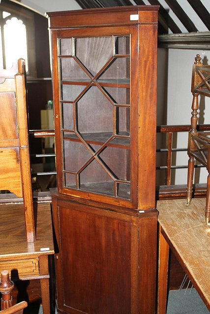 Appraisal: A TH CENTURY MAHOGANY FULL LENGTH CORNER CABINET with glazed