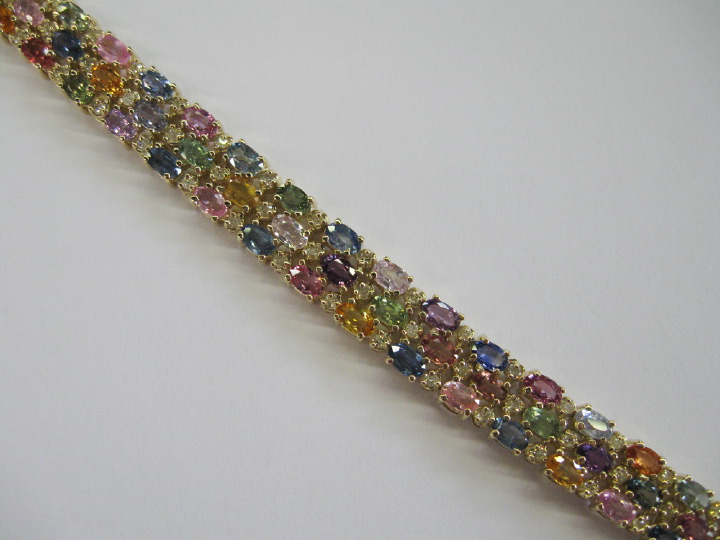 Appraisal: Fourteen-Karat Yellow Gold Fruit Salad Sapphire Bracelet featuring a flexible