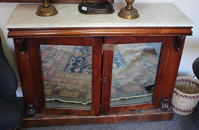 Appraisal: A WHITE MARBLE TOPPED ROSEWOOD SIDE CABINET with mirrored doors